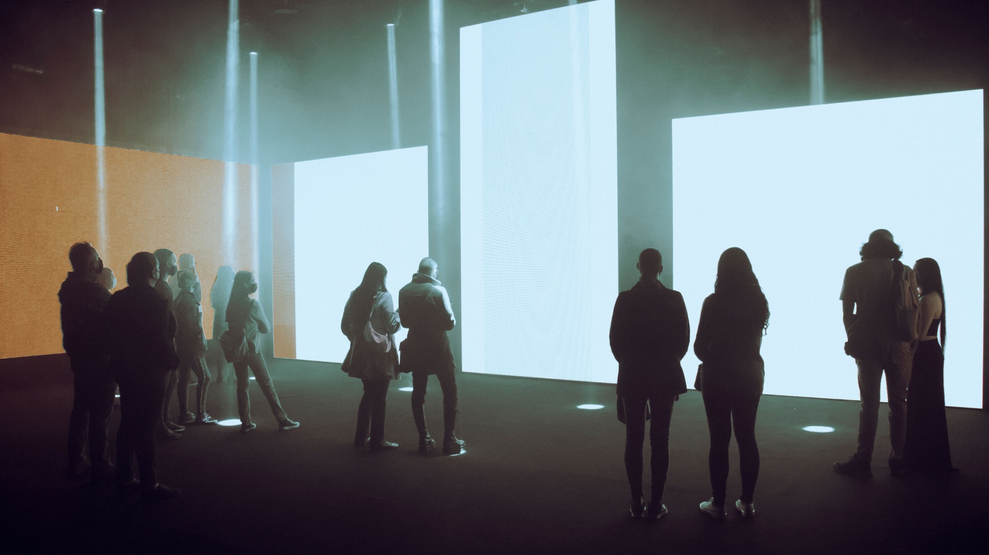 Glowing white panels in a dark gallery space