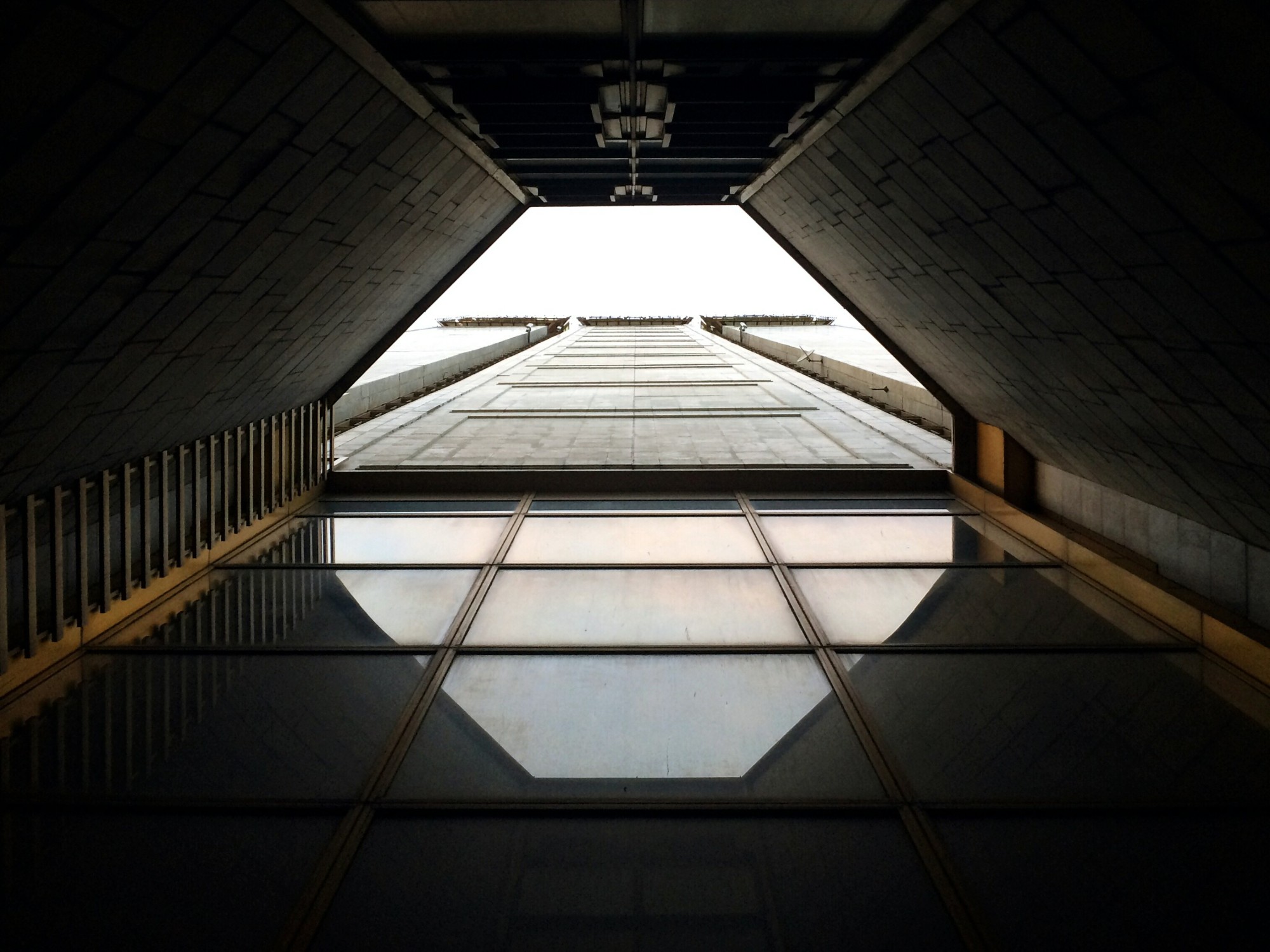Looking straight up through an architectural opening toward the sky